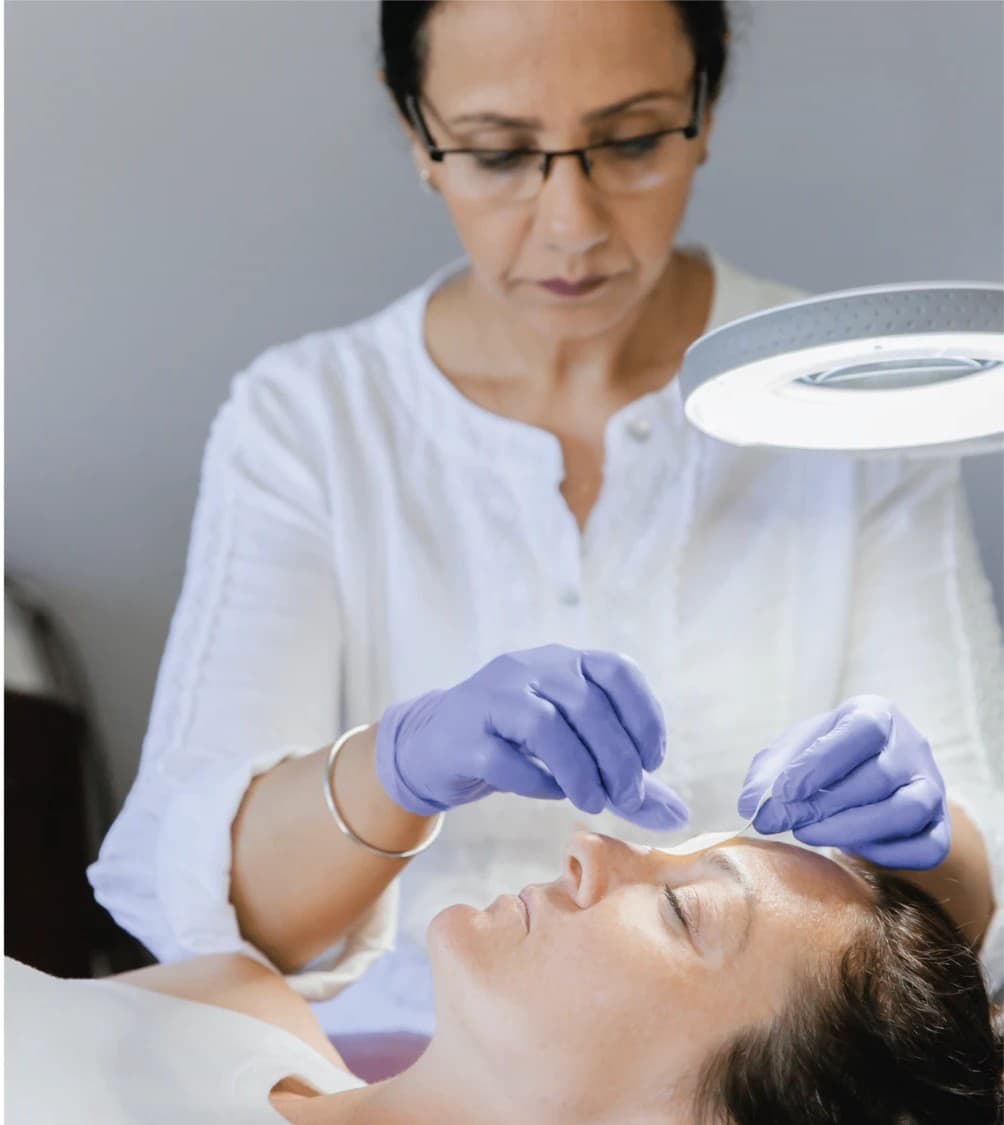 Elegance Studio esthetician performing facial treatment